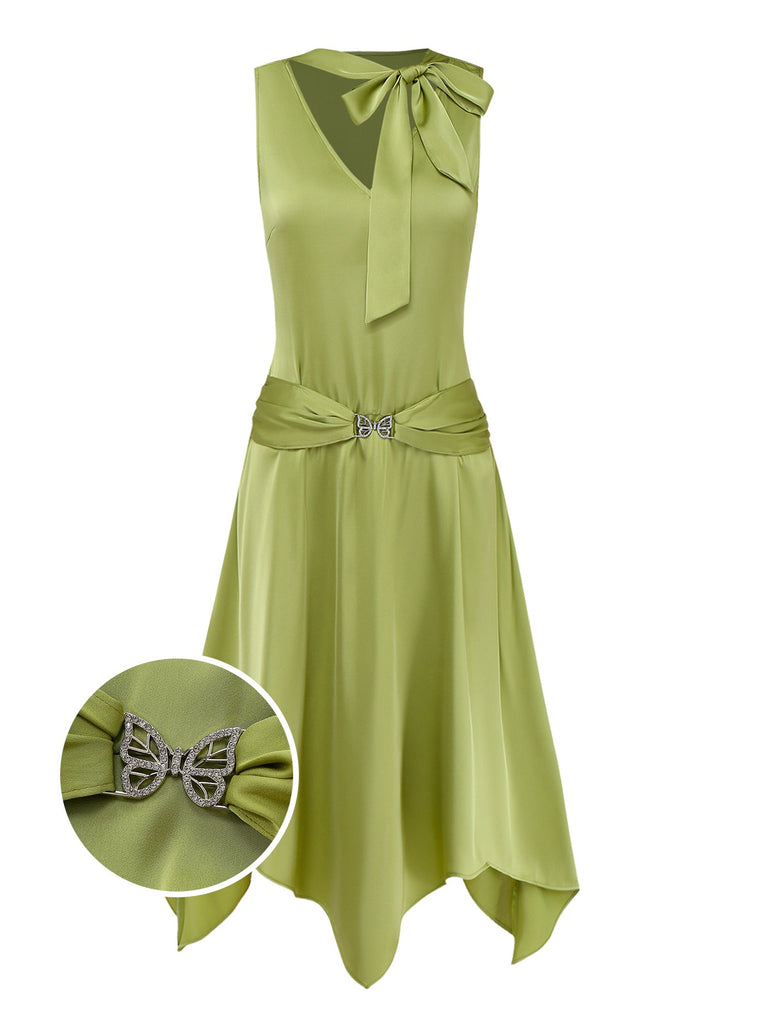 Green dress with a decorative bow detail on a white background