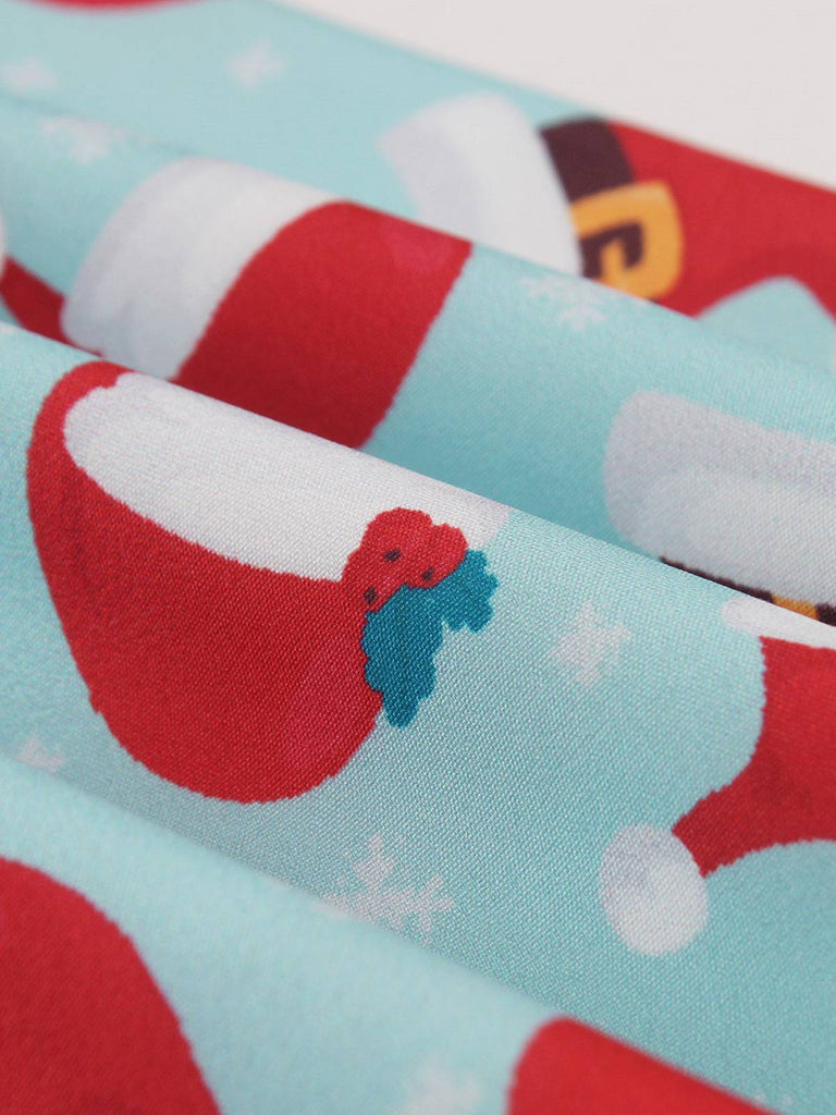 1950s Christmas Santa & Elk Print Swing Dress — a 1950s silhouette that turns sidewalks into runways