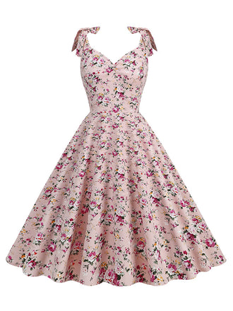 She slips into this 1950s Ditsy Floral Tie Swing Dress and suddenly it's a 1950s daydream