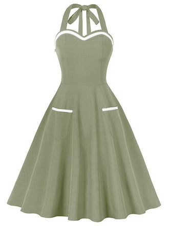 She slips into this 1950s Halter Pockets Backless Swing Dress and suddenly it's a 1950s daydream