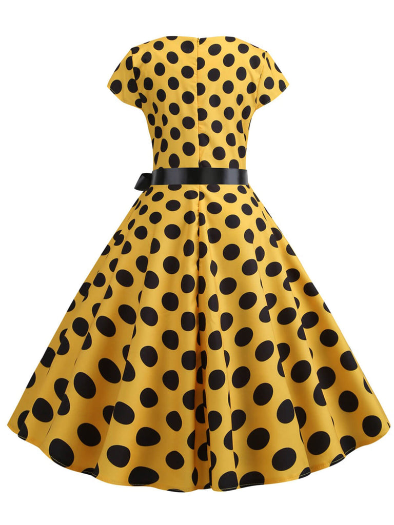 This 1950s Polka Dot Cap Sleeved Dress wraps her in 1950s elegance, one twirl at a time