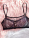 Black lace bralette on a pink fluffy background