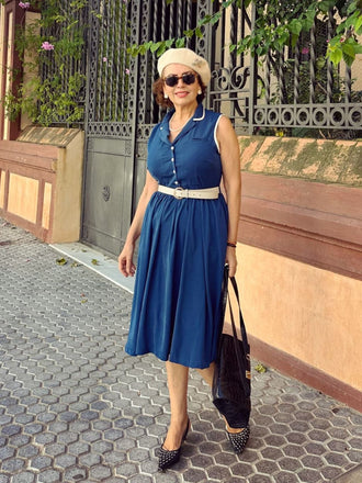 She slips into this 1960s Navy Blue Sleeveless Lapel Dress and suddenly it's a 1960s daydream