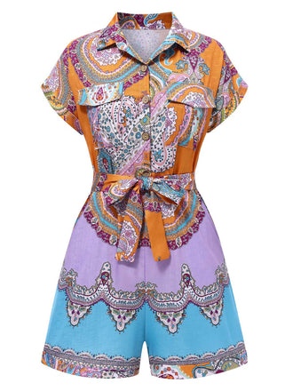 She pairs this 1970s Shirt Neck Paisley Print Belted Romper with confidence and 1970s charm