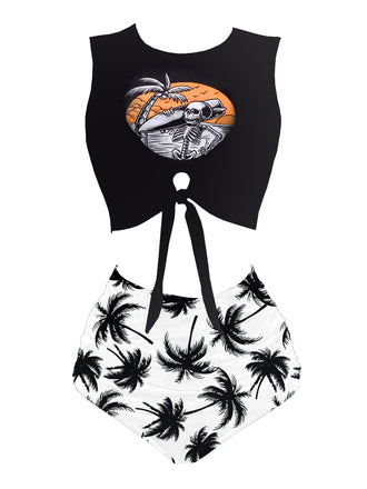 Black crop top with a graphic design and white high-waisted shorts with palm tree pattern on a white background