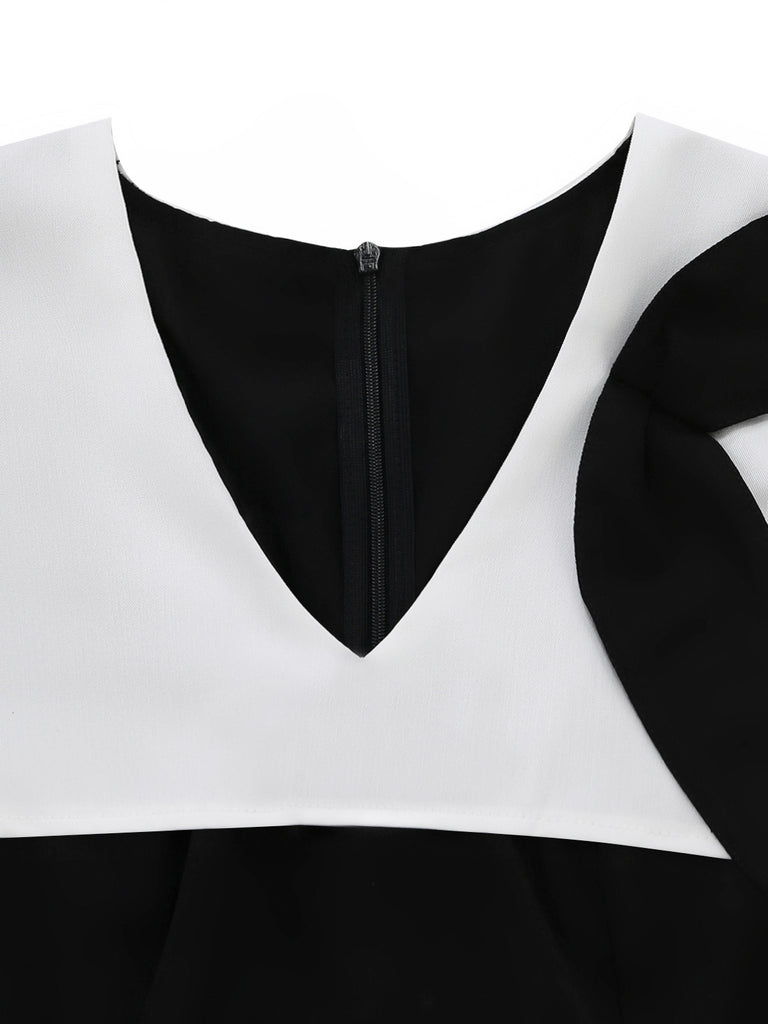 Close-up of a black and white garment with a zipper detail on a white background