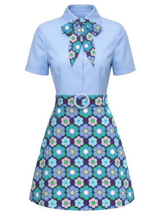 Light blue dress with floral patterned bow and skirt on a white background