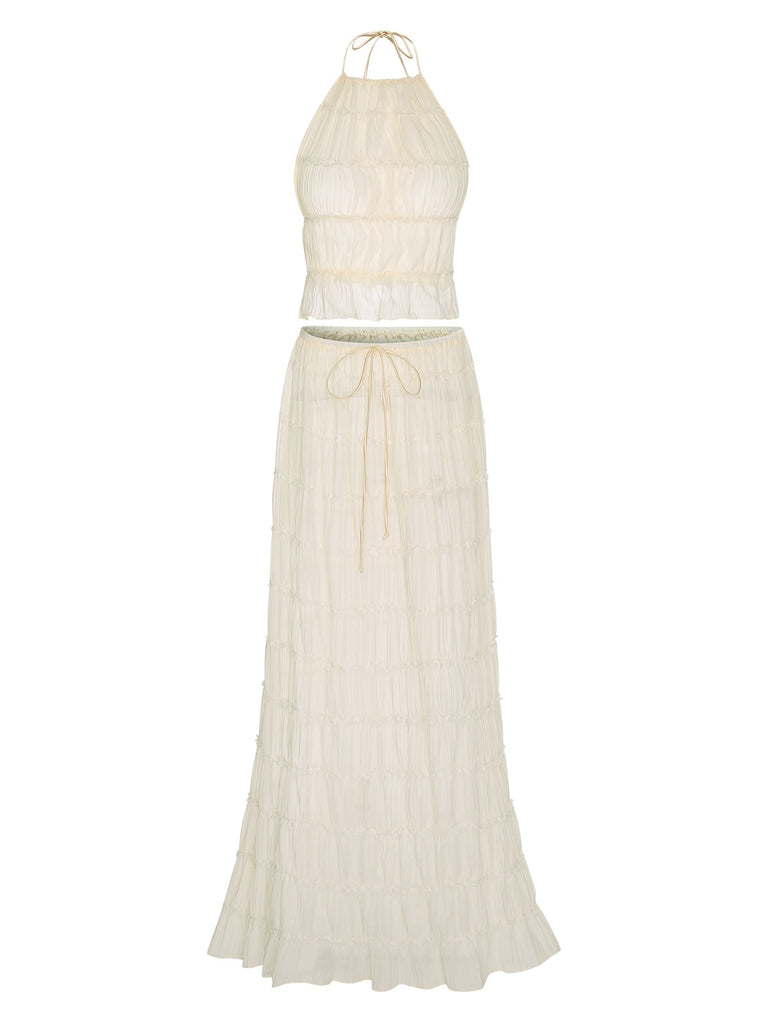 She pairs this 2PCS White 1970s Wrinkle Halter Backless Top & Skirts with confidence and 1970s charm