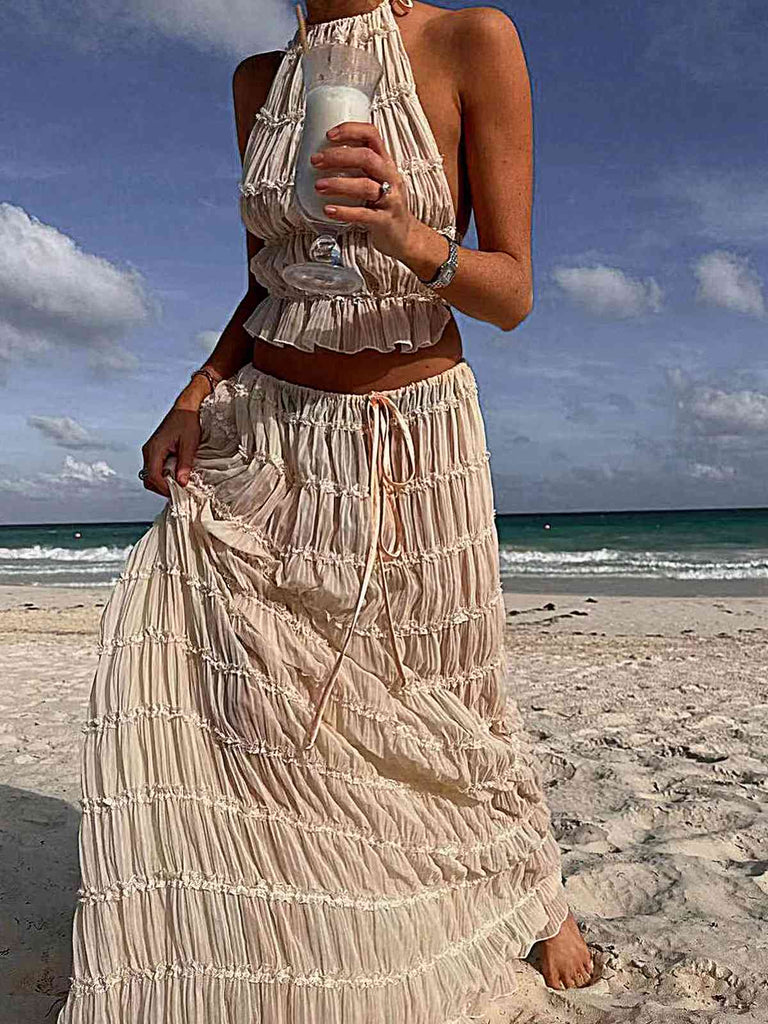 She pairs this 2PCS White 1970s Wrinkle Halter Backless Top & Skirts with confidence and 1970s charm