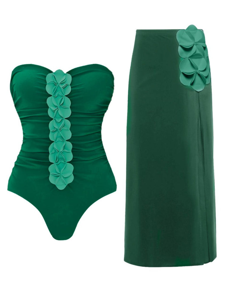 Green strapless swimsuit with floral details and matching green skirt on a white background