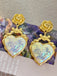 She adds this Alloy Rose Reflective Pleated Heart Earrings and suddenly it's vintage perfection