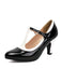 Black patent leather high heel shoe with a white insole on a white background