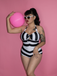 She's wearing Black & White 1950s Barbie Stripes Halter Swimsuit and the whole beach remembers the 1950s