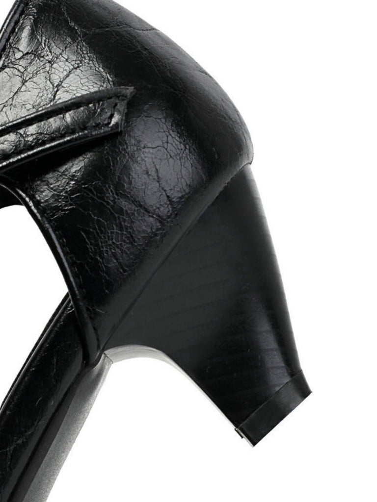 Close-up of a black leather shoe with a thick sole on a white background