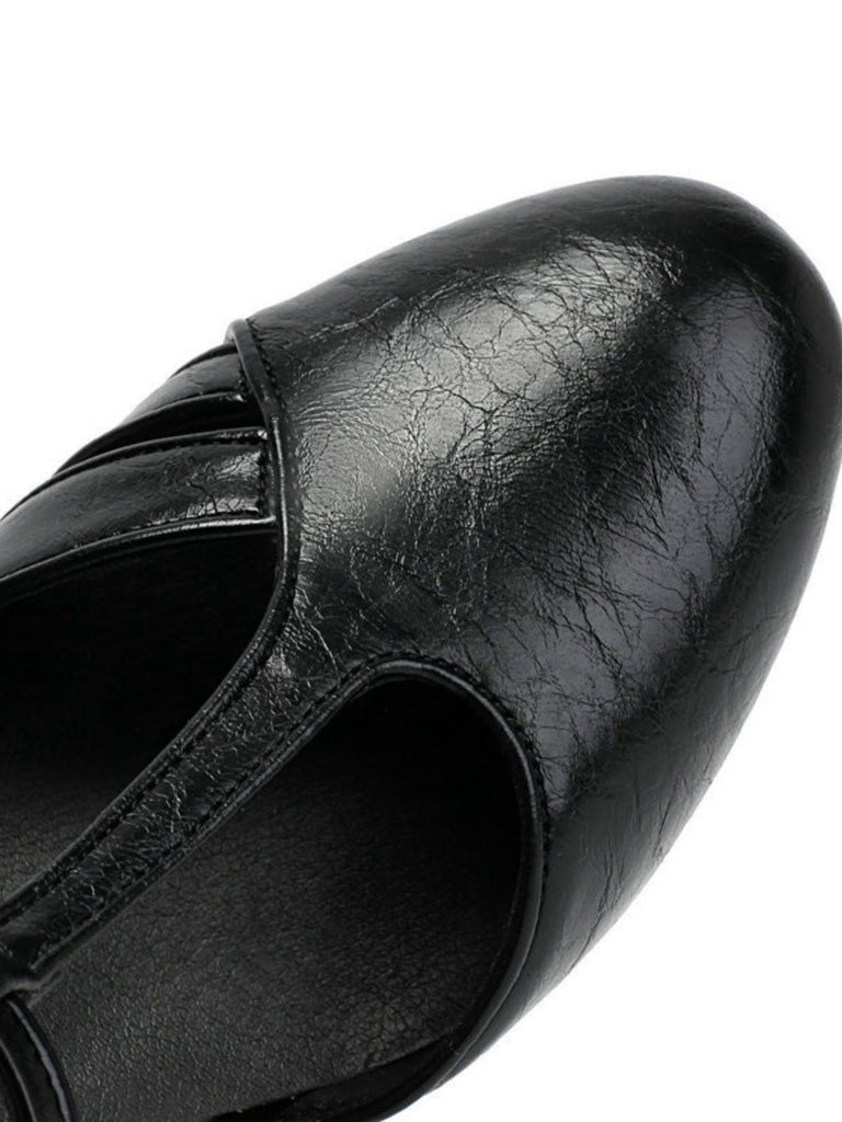 Close-up of a black leather shoe on a white background