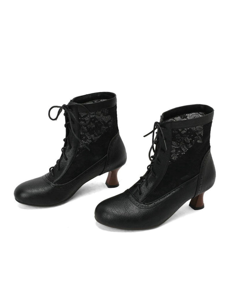 Pair of black lace-up boots with a white background