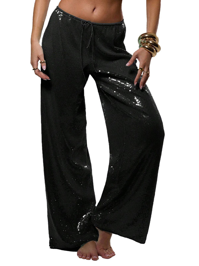Black sequin pants worn by a person on a white background