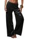 Black sequin pants worn by a person on a white background