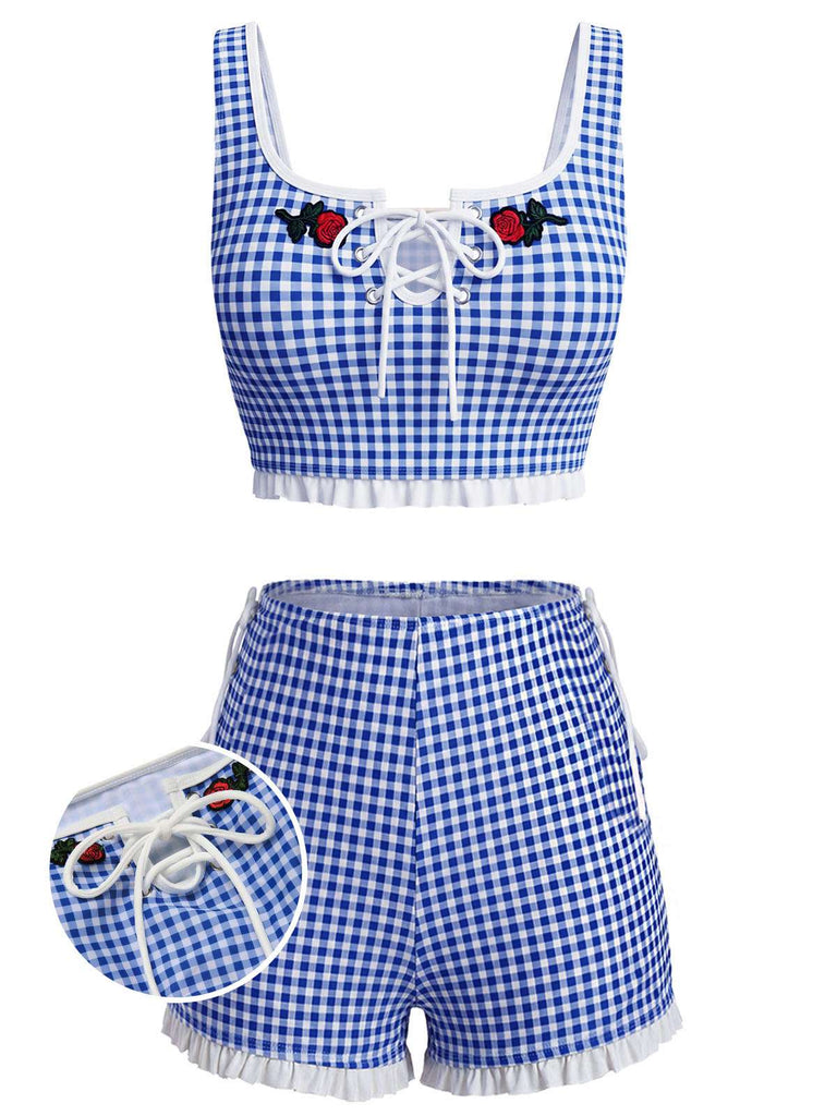 Blue and white checkered swimsuit with red heart details on a white background