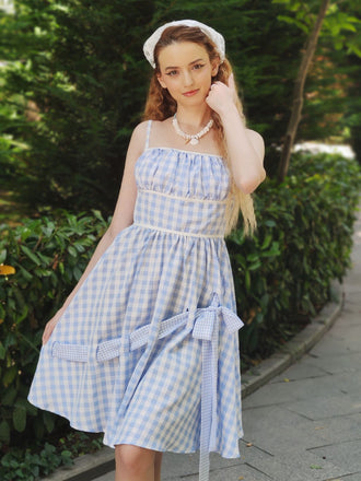 She slips into this Blue 1950s Spaghetti Strap Plaids Bow Decor Dress and suddenly it's a 1950s daydream