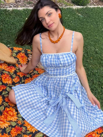 She slips into this Blue 1950s Spaghetti Strap Plaids Bow Decor Dress and suddenly it's a 1950s daydream