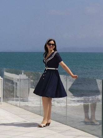 She slips into this Dark Blue 1950s Sailor Style Double Breasted Dress and suddenly it's a 1950s daydream