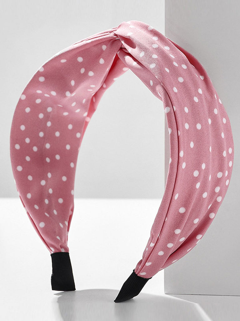 This Fabric Wide Brim Polka Dot Cross Headband whispers vintage secrets to those who notice