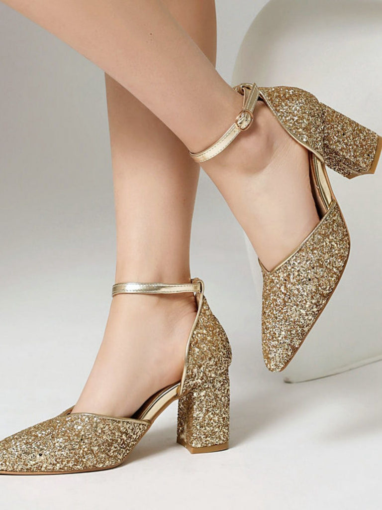 Gold glitter high heels on a neutral background