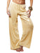 Gold sequin pants worn by a person on a white background