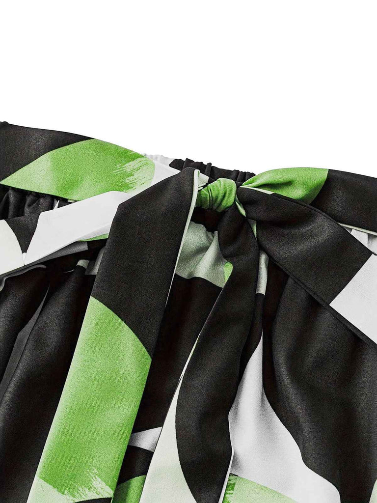 Close-up of a black, white, and green patterned fabric with a bow.