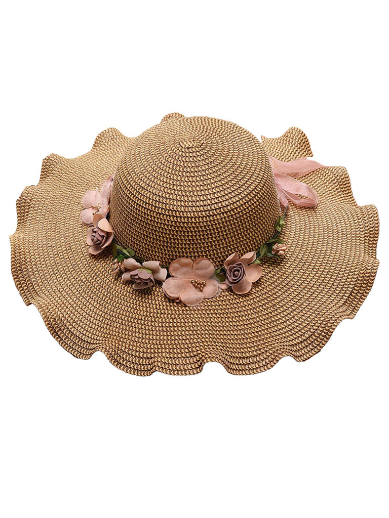 khaki straw hat with floral decorations on a white background