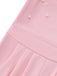 Close-up of a pink jumpsuit with pearl embellishments on a white background