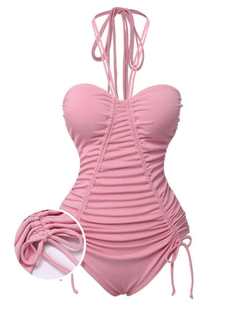 She's wearing Pink 1950s Halter Pleated Solid One-Piece Swimsuit and the whole beach remembers the 1950s
