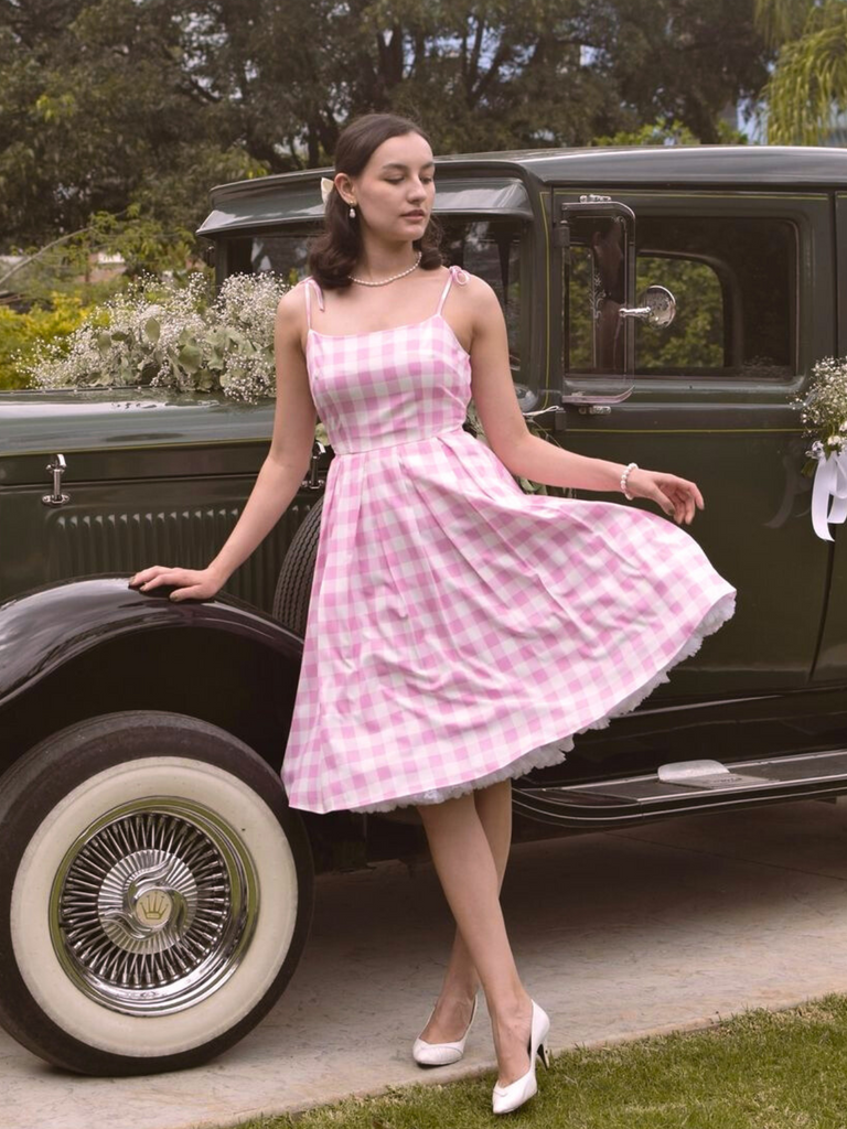 She slips into this Pink 1950s Spaghetti Strap Plaid Swing Dress and suddenly it's a 1950s daydream