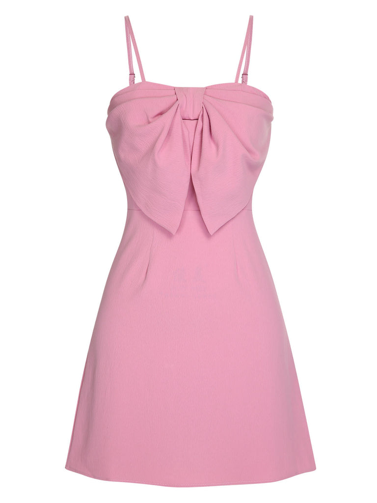 She slips into this Pink 1960s Solid Spaghetti Straps Bow Dress and suddenly it's a 1960s daydream