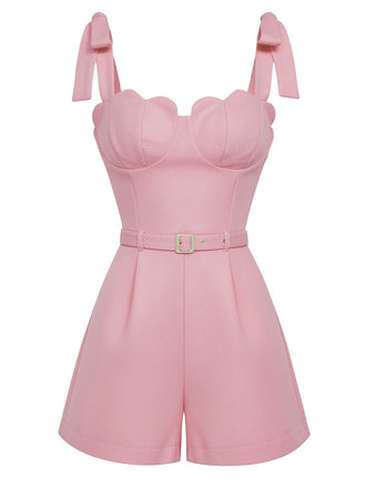 Pink romper with bow straps on a white background