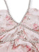 Close-up of a pink floral dress with a beaded neckline on a white background