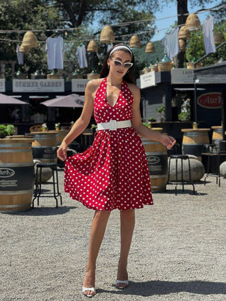 She slips into this Red 1950s Polka Dot Halter Dress and suddenly it's a 1950s daydream