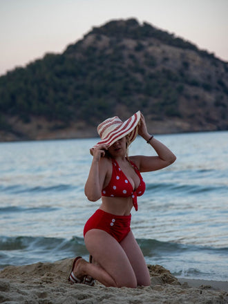 She's wearing Red 1950s Polka Dot Tie Halter Swimsuit and the whole beach remembers the 1950s
