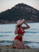 She's wearing Red 1950s Polka Dot Tie Halter Swimsuit and the whole beach remembers the 1950s