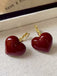 She adds this Retro Red 3D Heart Earrings and suddenly it's 1950s perfection