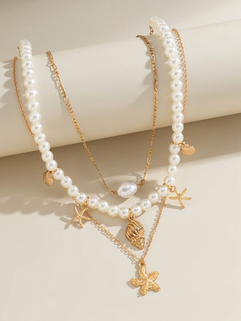 This Starfish Seashell Pearl Layered Chain Necklace carries vintage stories waiting to be told