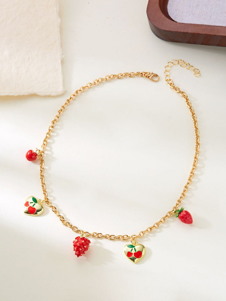 Gold necklace with strawberry-shaped charms on a light background