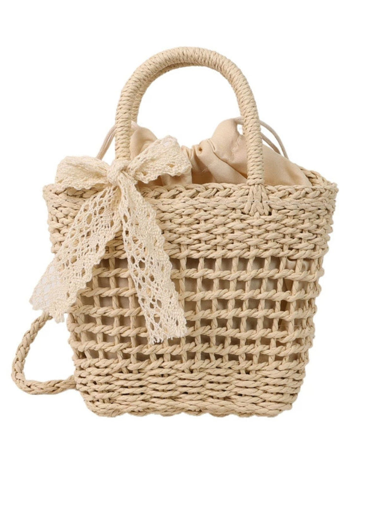 She adds this Vintage Boho Bow Straw Handbag and suddenly it's 1950s perfection