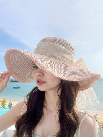 She adds this Vintage Lace Ribbon Wide-Brim Sun Hat and suddenly it's 1950s perfection