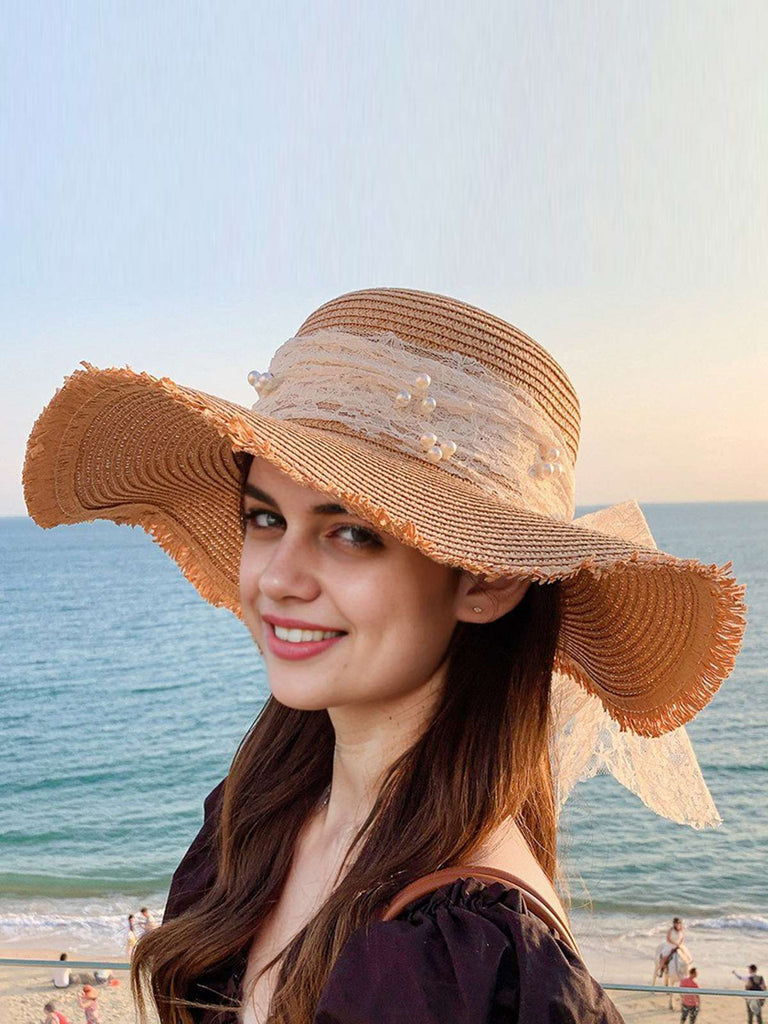 She adds this Vintage Lace Ribbon Wide-Brim Sun Hat and suddenly it's 1950s perfection