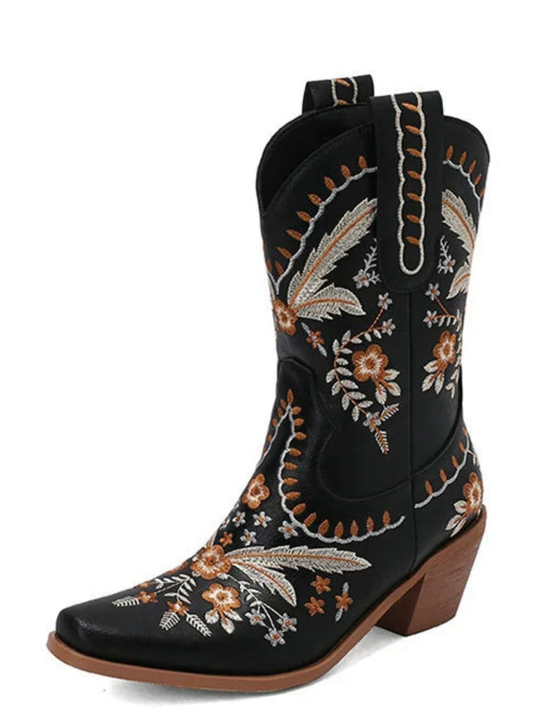 Black cowboy boot with floral embroidery on a white background