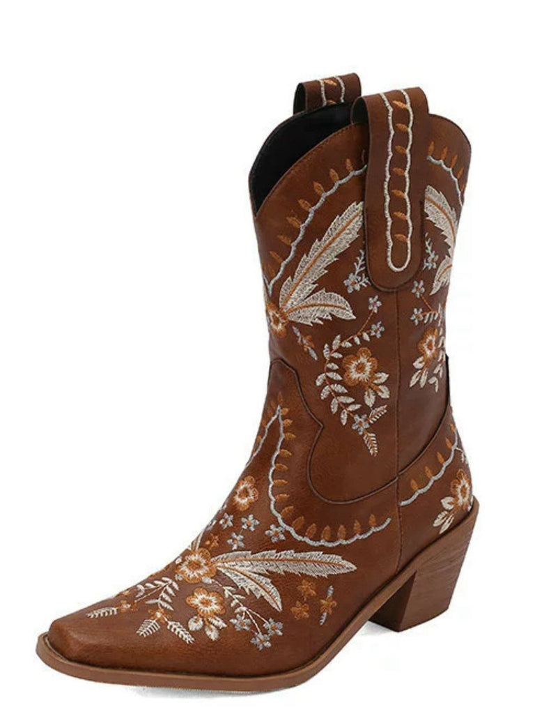 Brown cowboy boot with floral embroidery on a white background
