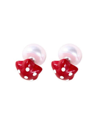 Pair of red star-shaped earrings with white polka dots on a white background