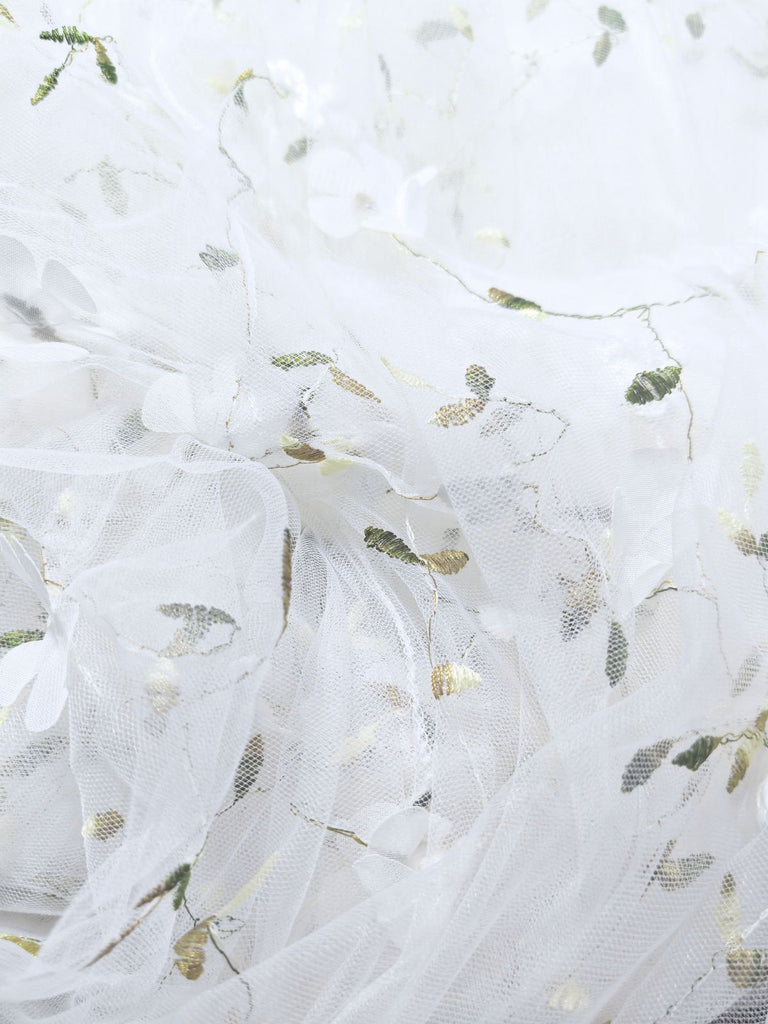 White fabric with green floral patterns